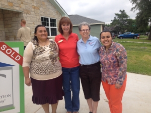 Debbie Eller, from City of College Station, celebrate the home dedication with the Sanchez family