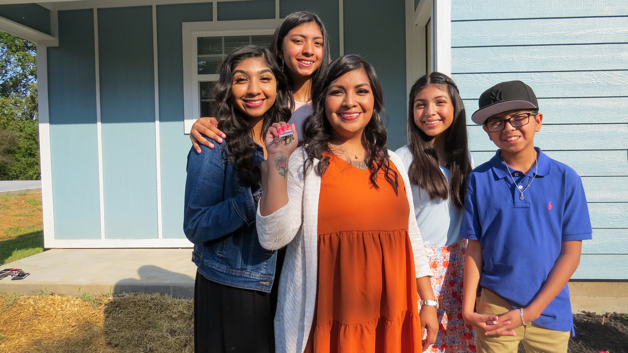 The Ocampo family showing off the keys to their new home. 